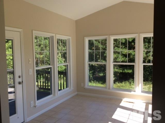136 Locke Woods Road Raleigh, NC 27603 - Photo 14 of 18 a view of backyard with large windows and plants