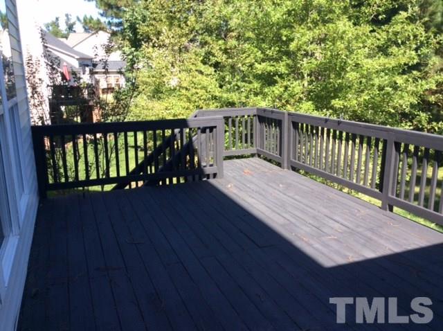 136 Locke Woods Road Raleigh, NC 27603 - Photo 16 of 18 a balcony with wooden floor and yard in the back