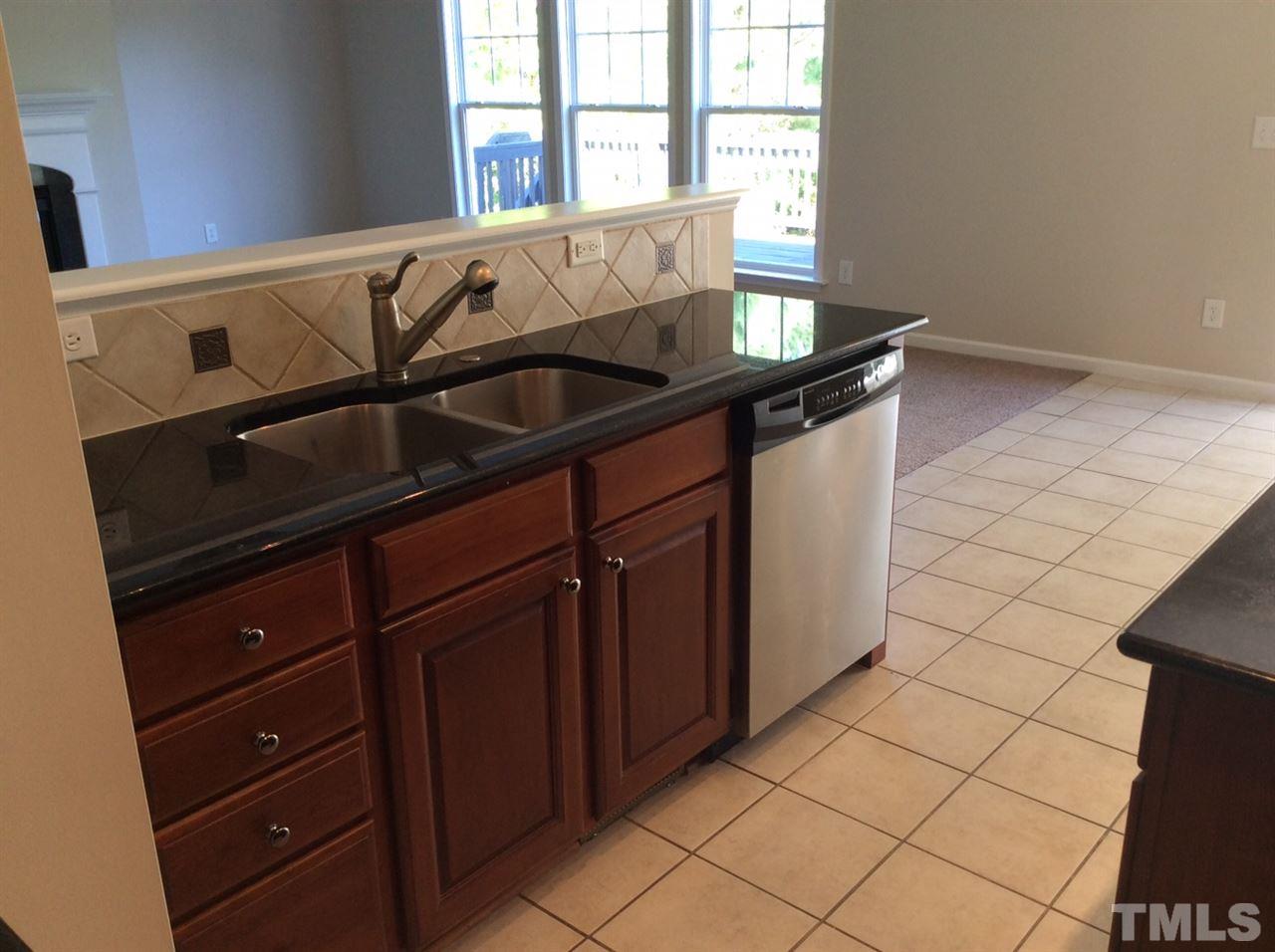 136 Locke Woods Road Raleigh, NC 27603 - Photo 3 of 18 a kitchen with a sink and cabinets