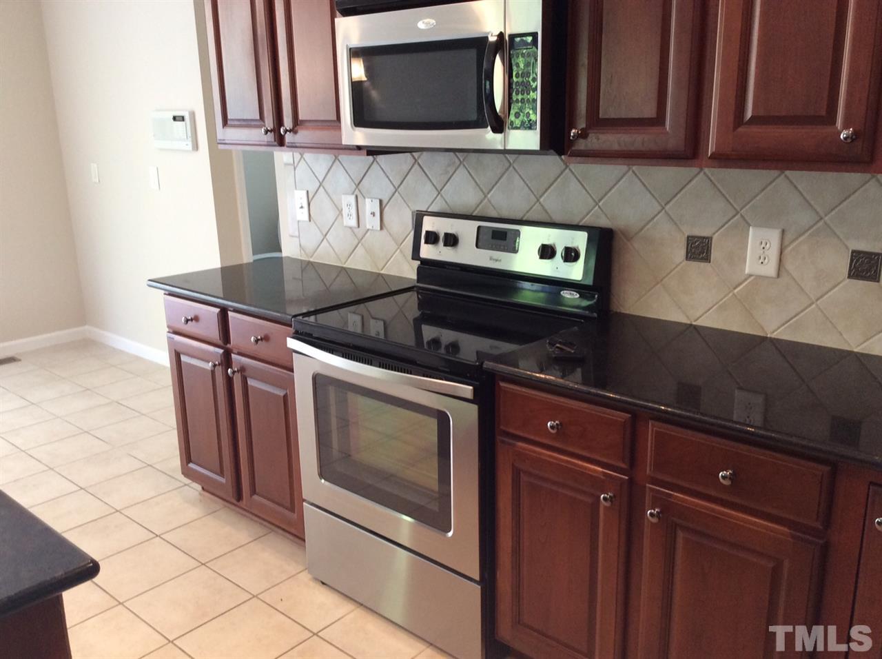 136 Locke Woods Road Raleigh, NC 27603 - Photo 4 of 18 a kitchen with stainless steel appliances granite countertop a stove and a microwave