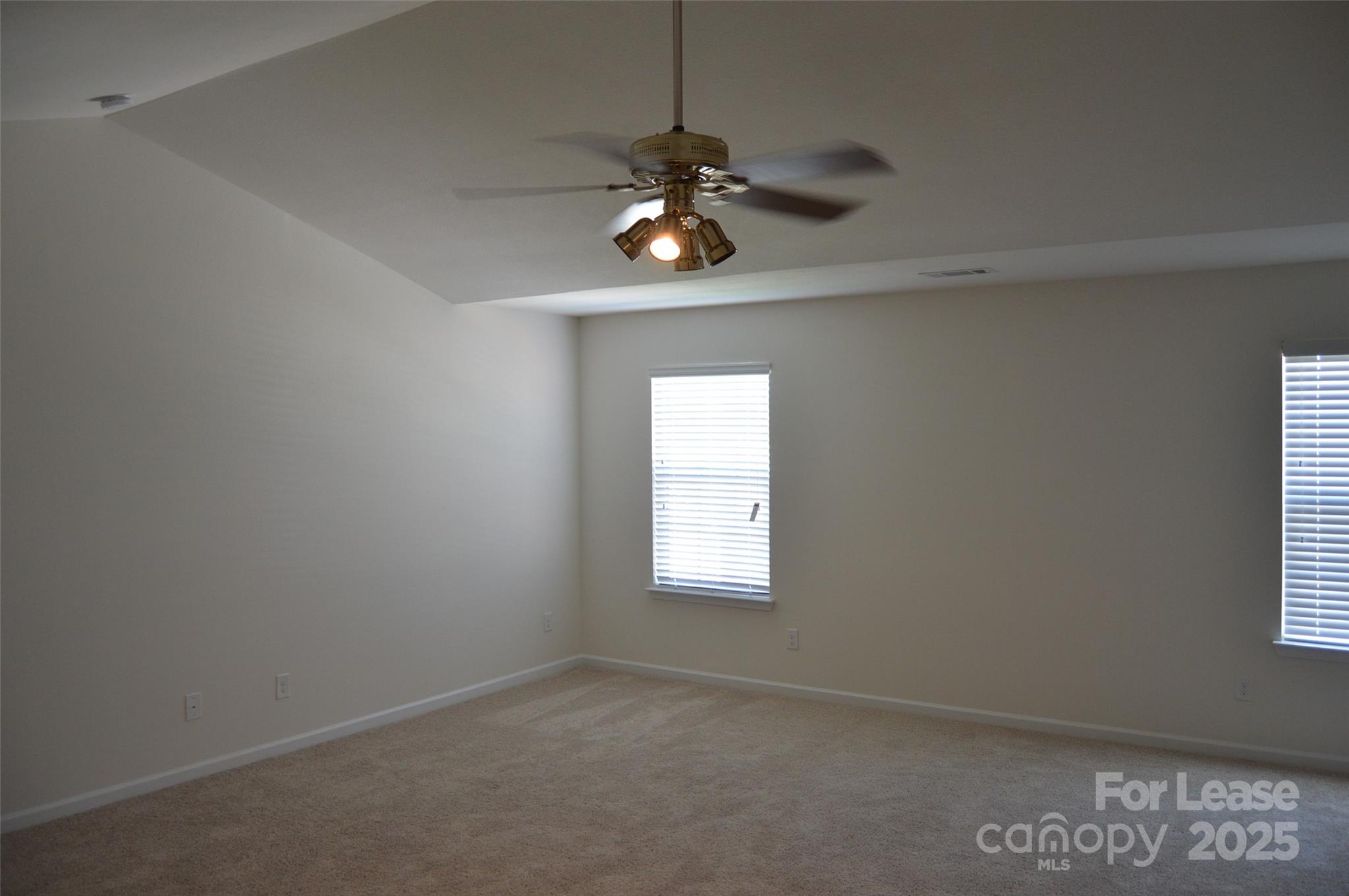 117 Quail Springs Road Statesville, NC 28677 - Photo 12 of 22 an empty room with windows and fan