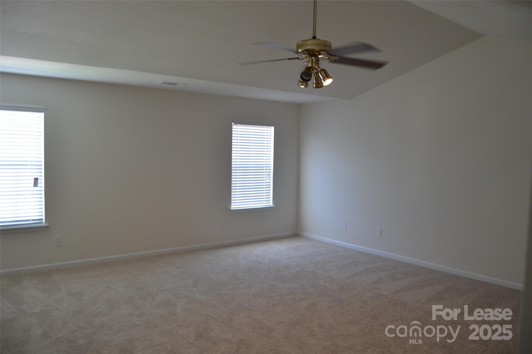 117 Quail Springs Road Statesville, NC 28677 - Photo 13 of 22 an empty room with a window and a fan
