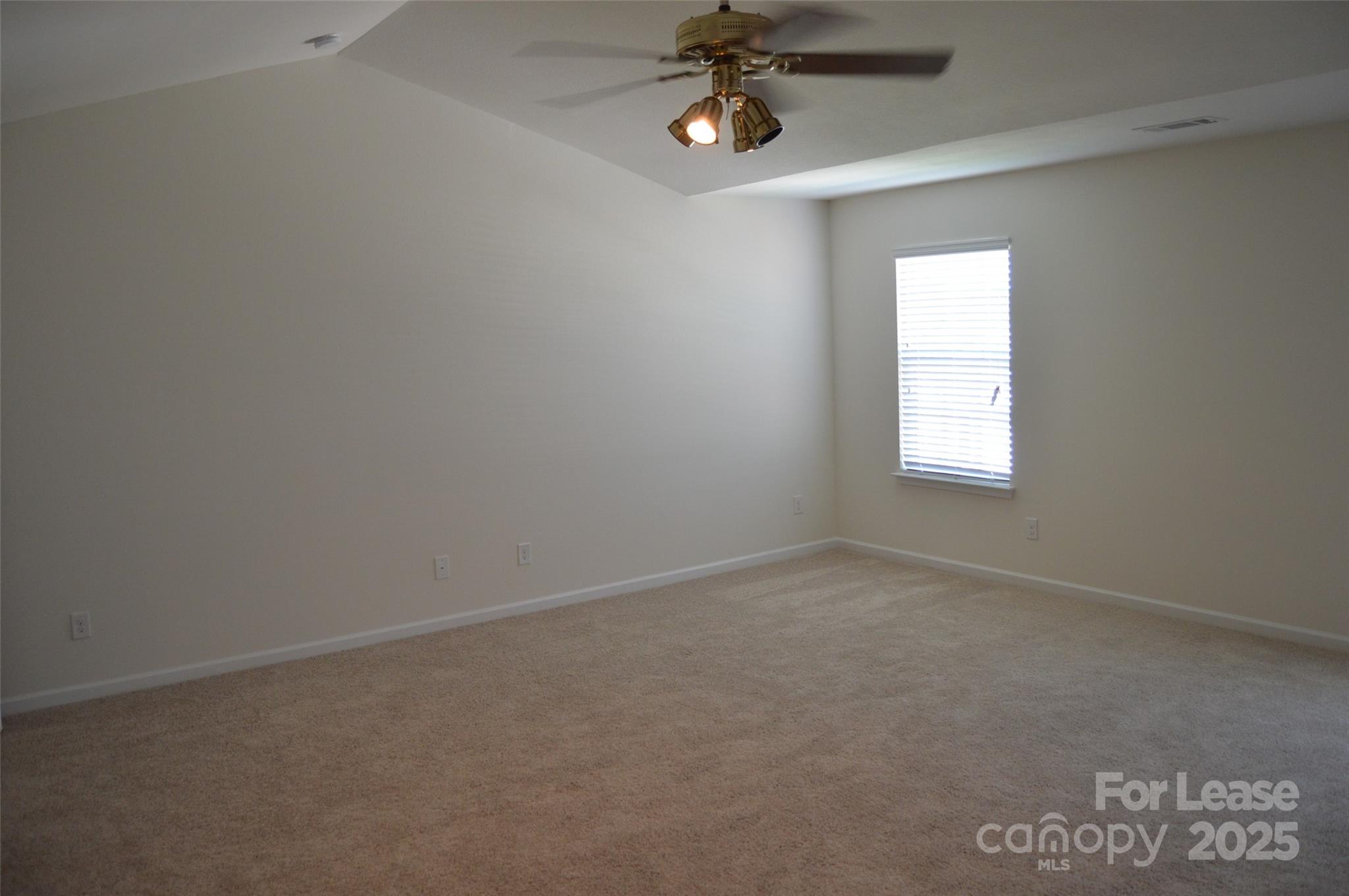 117 Quail Springs Road Statesville, NC 28677 - Photo 14 of 22 an empty room with windows and chandelier fan