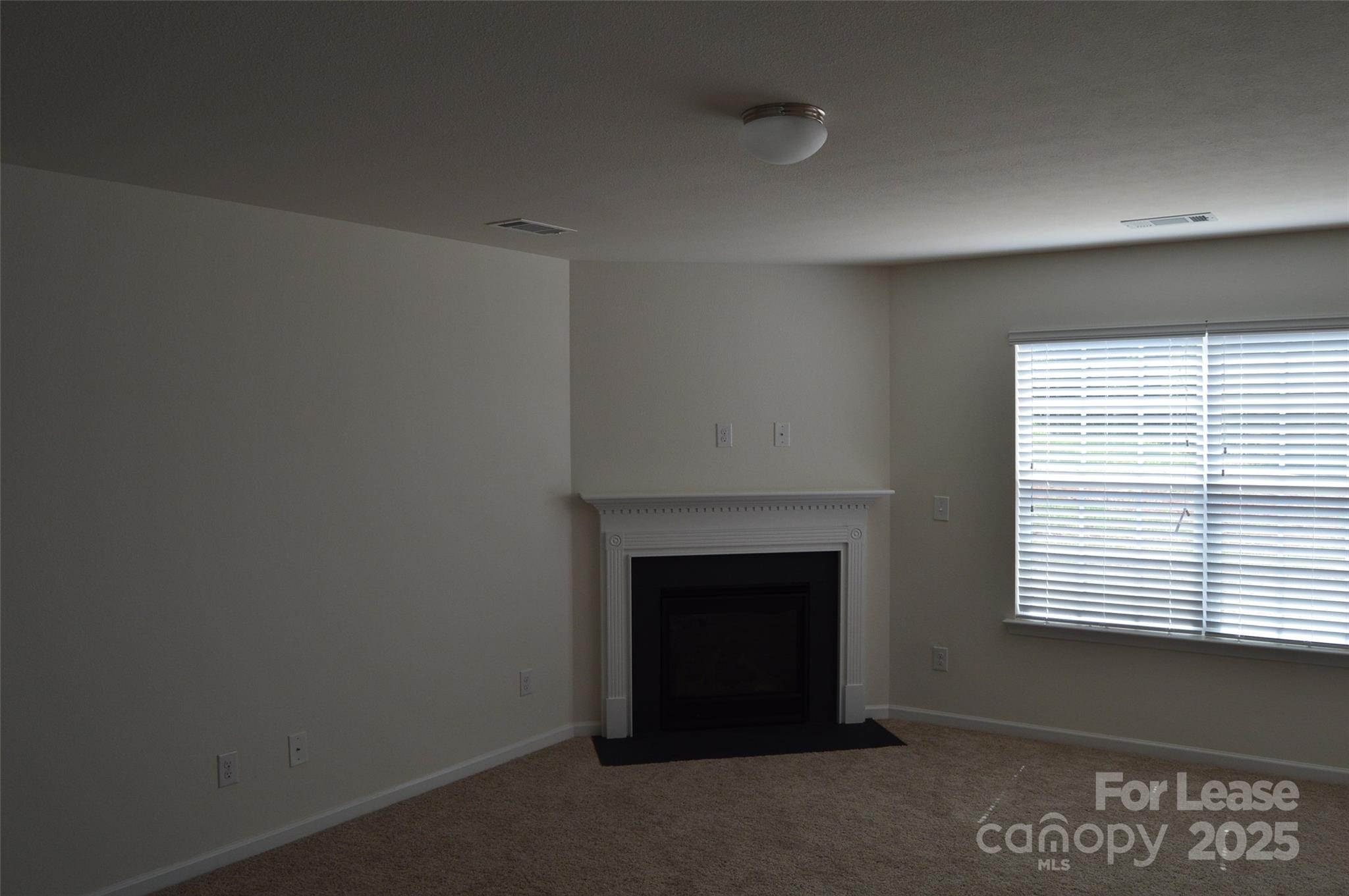 117 Quail Springs Road Statesville, NC 28677 - Photo 2 of 22 a room with a fireplace and a window