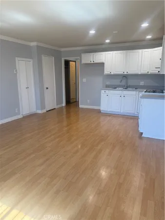 a view of a kitchen with a sink and cabinets