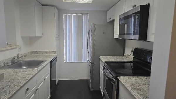 a kitchen that has a sink and a stove