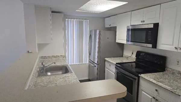 a kitchen with a stove and a refrigerator