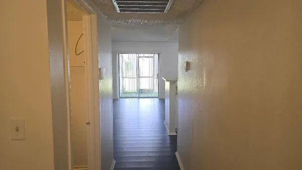 a view of hallway with wooden floor