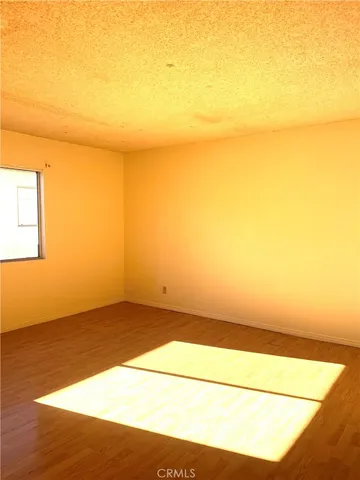 a view of an empty room and wooden floor