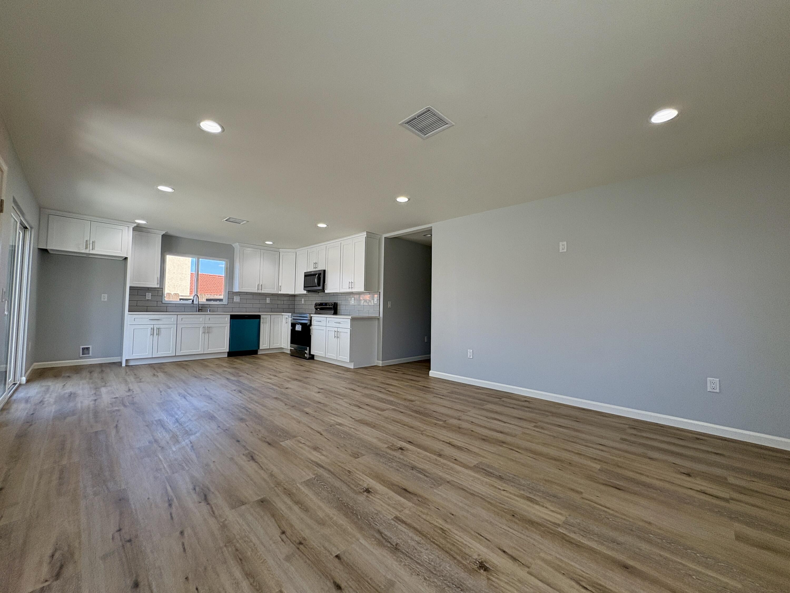 37132 Kendrick Circle, Unit B Palmdale, CA 93550 - Photo 3 of 10 a view of a kitchen with a sink and a stove top oven