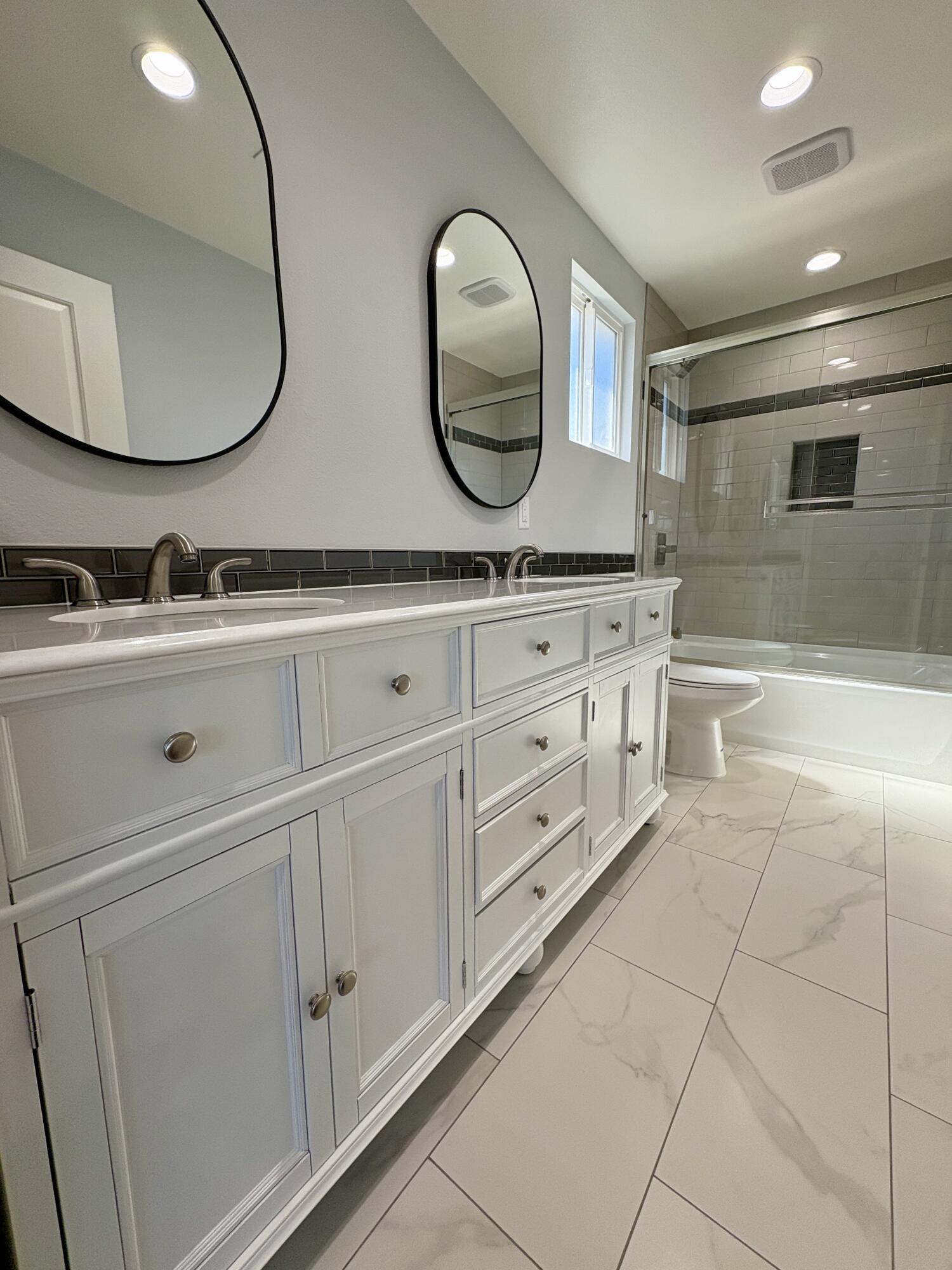 37132 Kendrick Circle, Unit B Palmdale, CA 93550 - Photo 10 of 10 a bathroom with a double vanity sink and a mirror