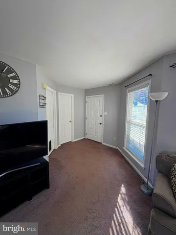 a view of empty room with window and fireplace