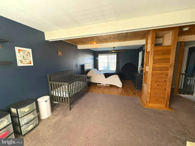 a bedroom with furniture and a window