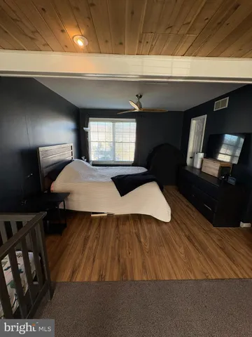 a bedroom with a bed and a mirror