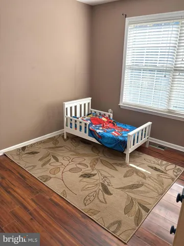 a bedroom with wooden bed and window