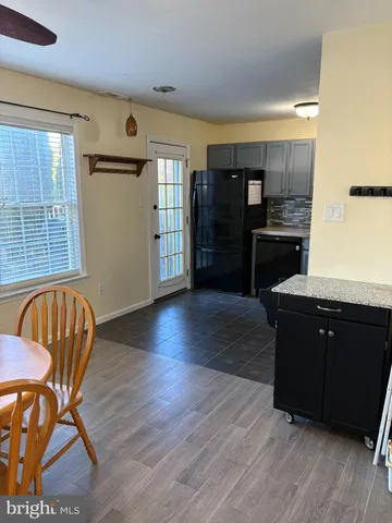 a kitchen with stainless steel appliances wooden floors and wooden cabinets