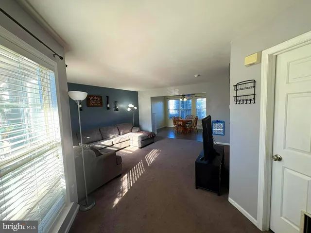 a view of living room with furniture and a window
