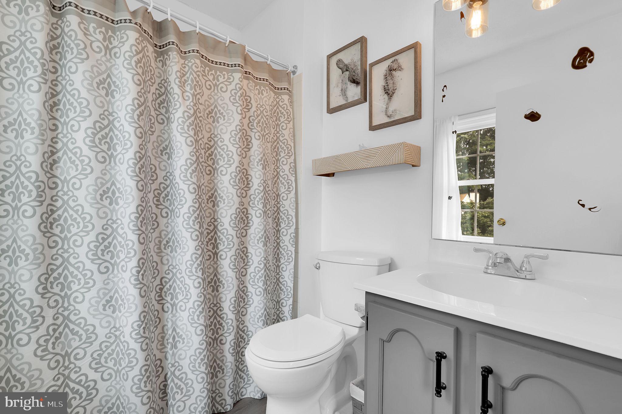 7922 Red Barn Way Elkridge, MD 21075 - Photo 16 of 31 a bathroom with a granite countertop sink and a toilet