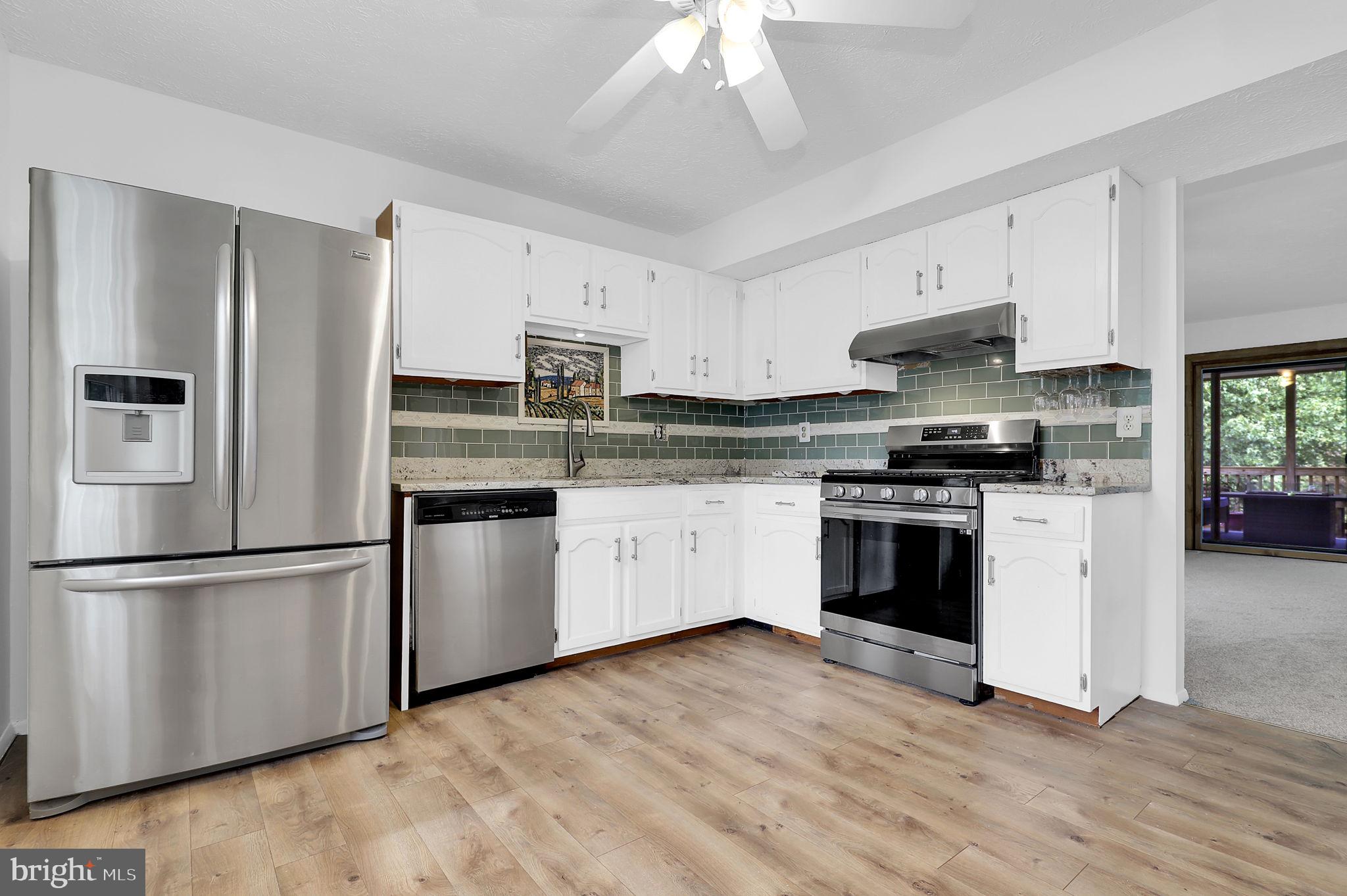 7922 Red Barn Way Elkridge, MD 21075 - Photo 3 of 31 a kitchen with stainless steel appliances white cabinets and a refrigerator