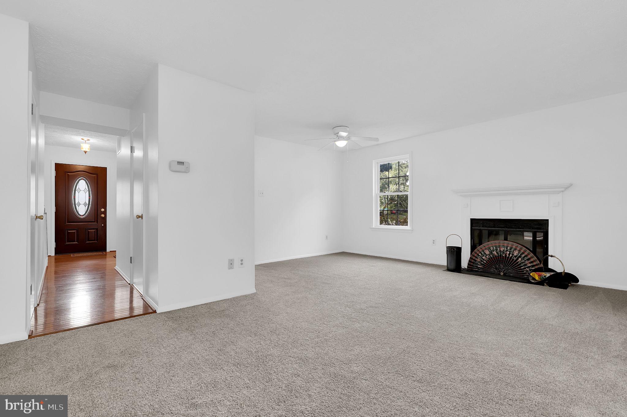 7922 Red Barn Way Elkridge, MD 21075 - Photo 5 of 31 an empty room with fireplace and windows