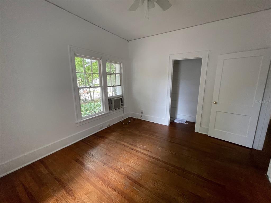 2635 West University Avenue Gainesville, FL 32607 - Photo 13 of 15 an empty room with wooden floor and windows