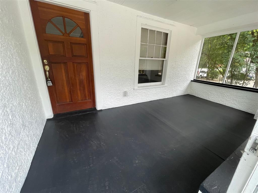 2635 West University Avenue Gainesville, FL 32607 - Photo 2 of 15 an empty room with windows wooden floor and front door