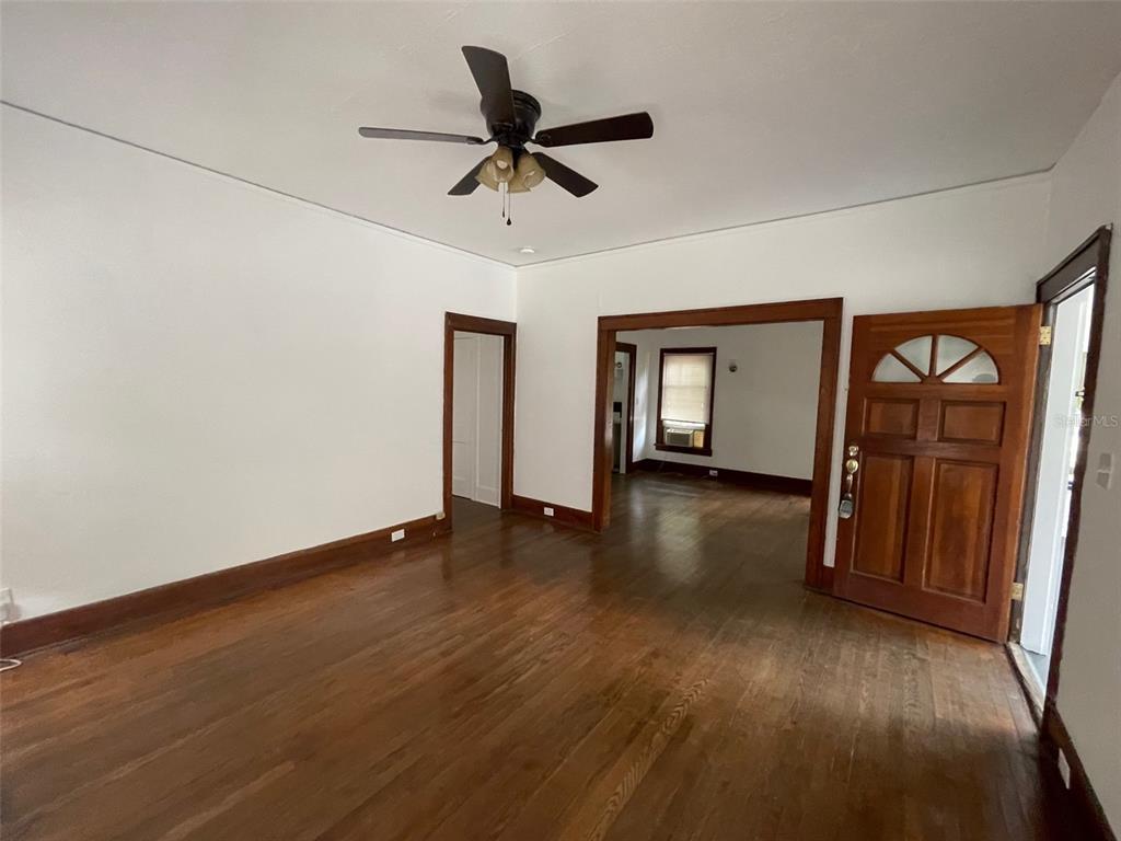 2635 West University Avenue Gainesville, FL 32607 - Photo 4 of 15 a view of empty room with wooden floor and fan