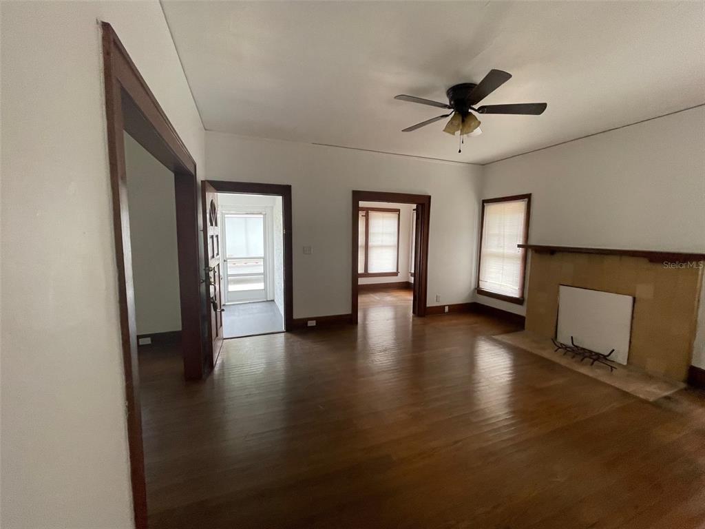 2635 West University Avenue Gainesville, FL 32607 - Photo 9 of 15 a view of an empty room with a window and wooden floor