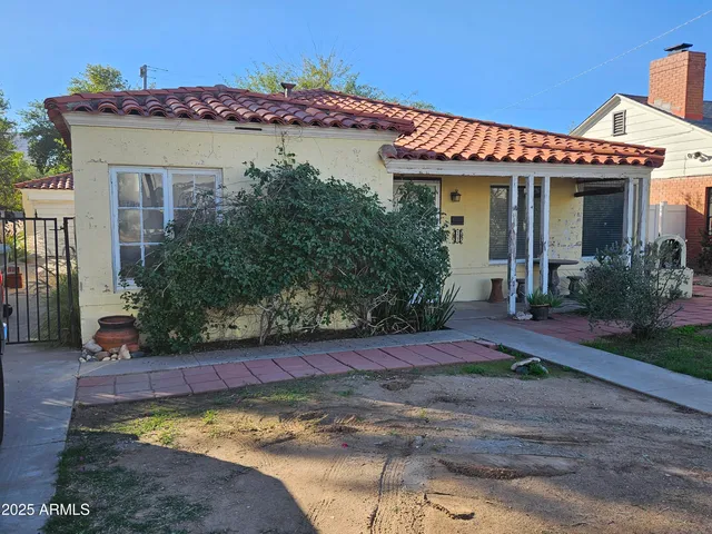 a view of a house with potted plants