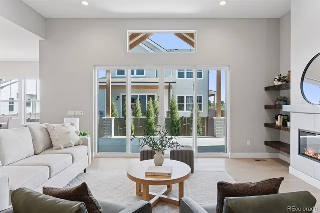 a living room with furniture and view of kitchen