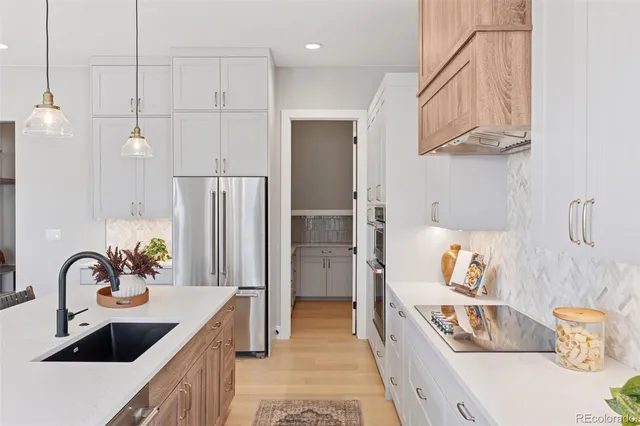a kitchen that has a lot of cabinets and refrigerator