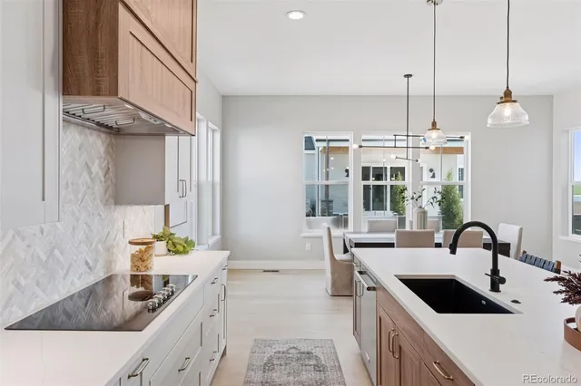 a large kitchen with a table and chairs