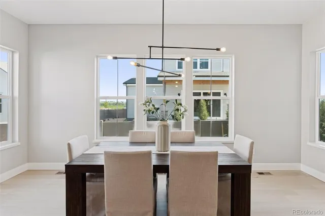 a kitchen that has a lot of cabinets a sink and a wooden floor