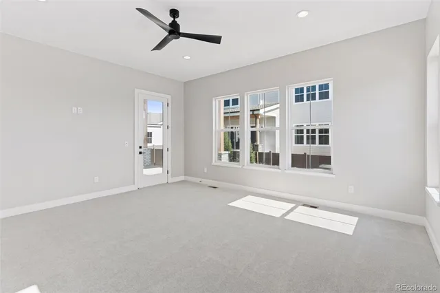 an empty room with windows and entrance