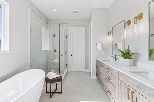 a white bath tub sitting next to a white toilet and a shower