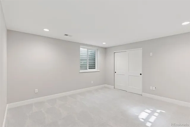a bathroom with a sink toilet double vanity and shower