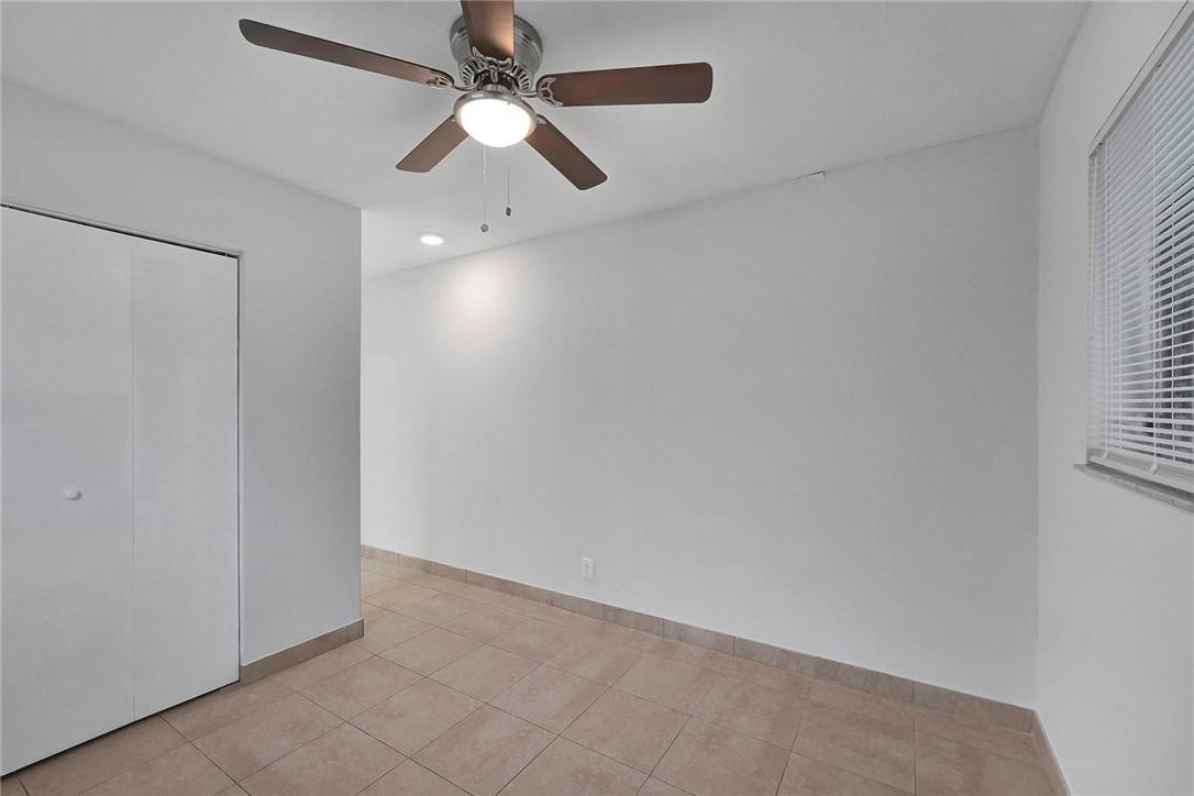 313 Southwest 9th Terrace Hallandale Beach, FL 33009 - Photo 11 of 20 an empty room with a window and a fan
