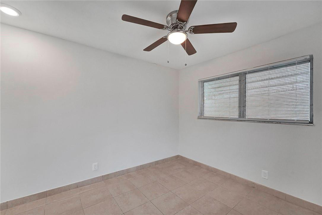313 Southwest 9th Terrace Hallandale Beach, FL 33009 - Photo 12 of 20 an empty room with a window and a fan