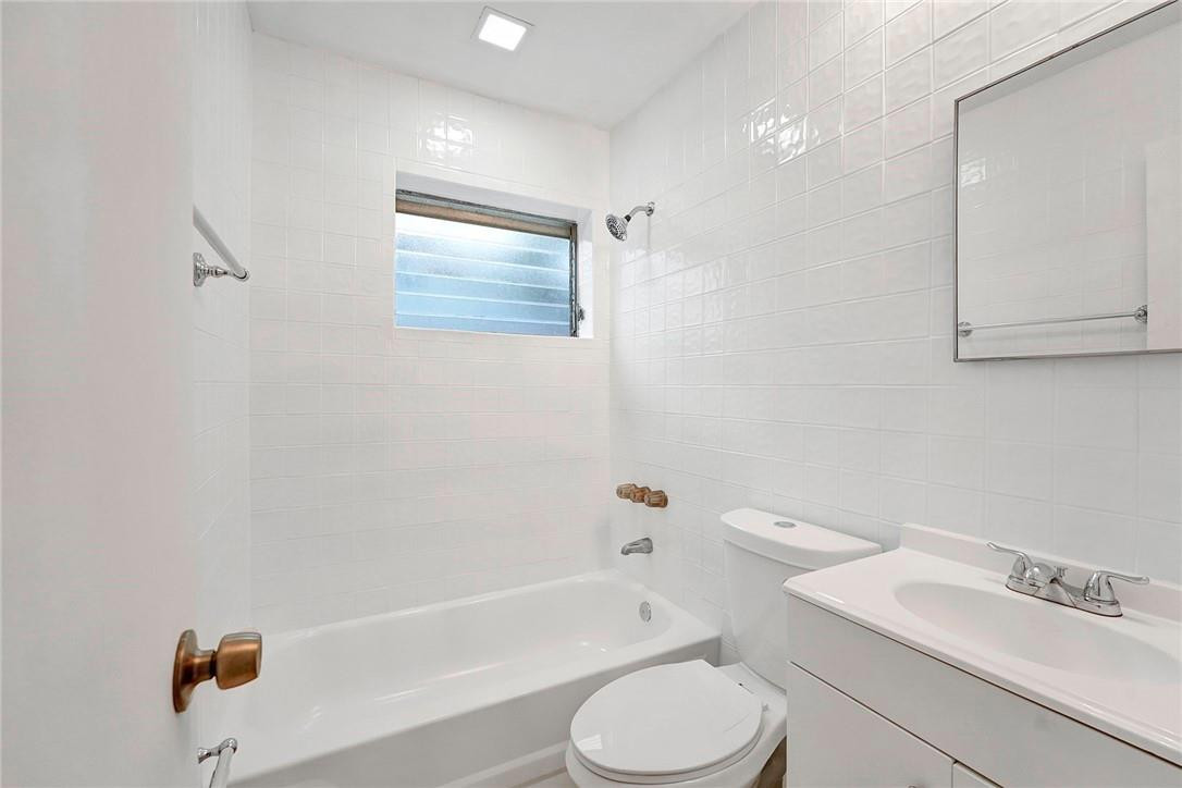 313 Southwest 9th Terrace Hallandale Beach, FL 33009 - Photo 13 of 20 a bathroom with a sink a toilet and bathtub