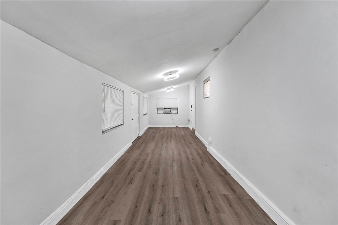 313 Southwest 9th Terrace Hallandale Beach, FL 33009 - Photo 14 of 20 a view of a room with wooden floor and staircase