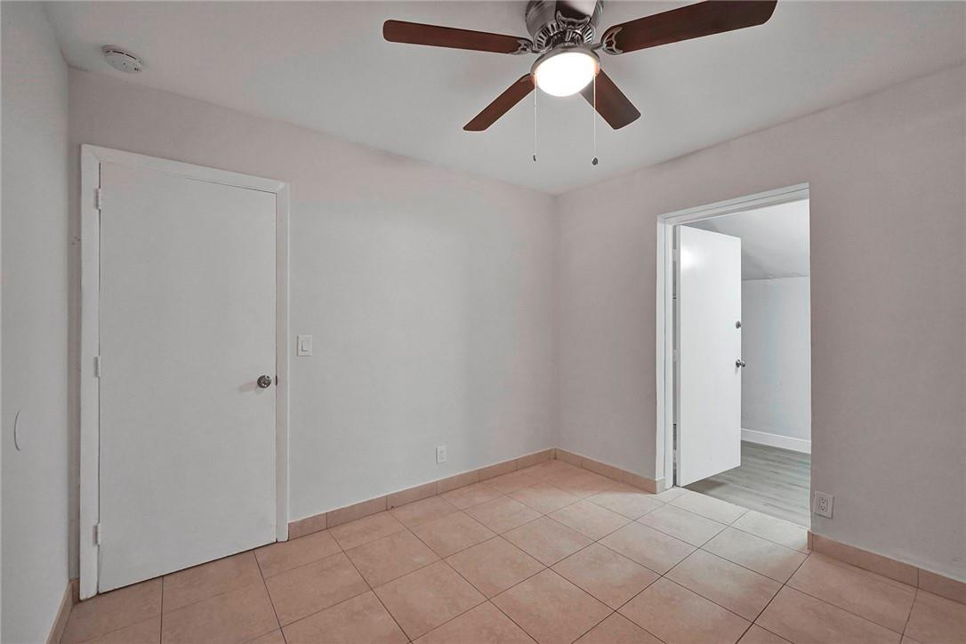 313 Southwest 9th Terrace Hallandale Beach, FL 33009 - Photo 15 of 20 an empty room with closet and a chandelier fan