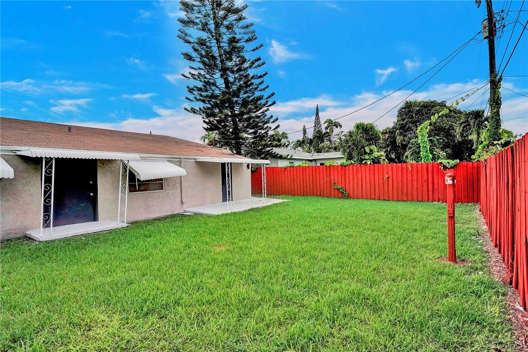 313 Southwest 9th Terrace Hallandale Beach, FL 33009 - Photo 19 of 20 a view of a house with a yard