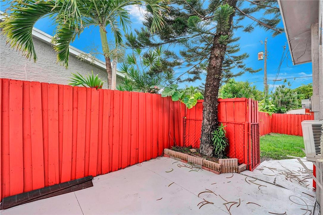 313 Southwest 9th Terrace Hallandale Beach, FL 33009 - Photo 20 of 20 a view of a backyard with potted plants and large trees