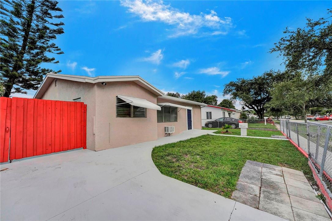 313 Southwest 9th Terrace Hallandale Beach, FL 33009 - Photo 2 of 20 a view of a house with a backyard