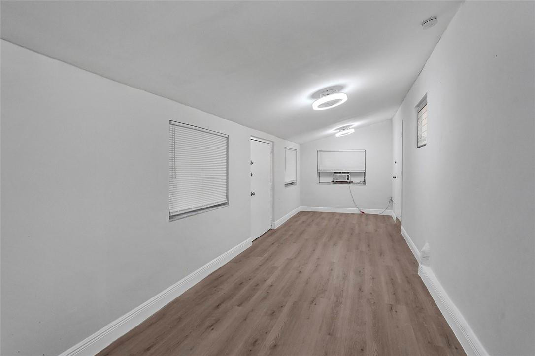 313 Southwest 9th Terrace Hallandale Beach, FL 33009 - Photo 10 of 20 a view of a room with wooden floor and windows