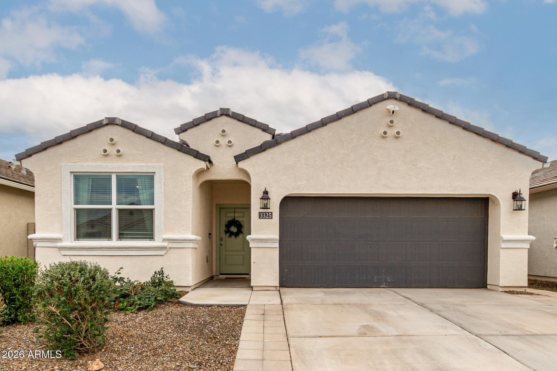 a front view of a house with a yard and garage