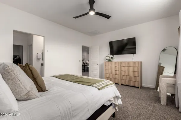 a bedroom with a large bed and a window