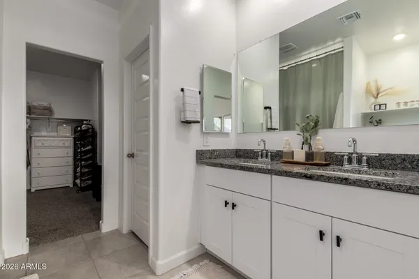 a view of a walk in closet and a bathroom