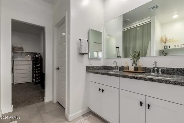 a view of a walk in closet and a bathroom