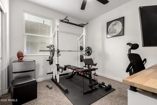 a bathroom with a granite countertop sink a toilet and a mirror
